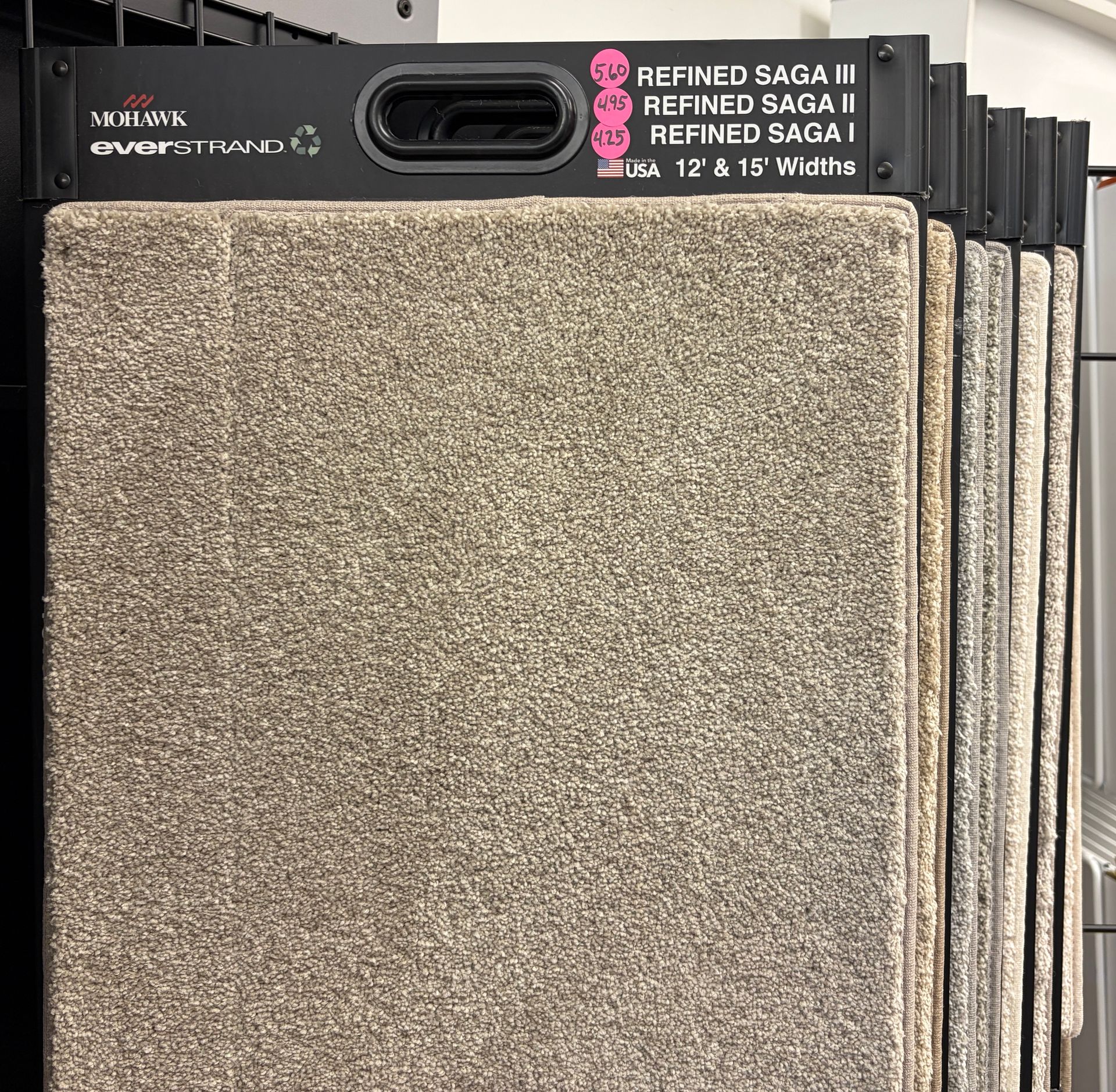 Carpet samples in various neutral shades. Display features 