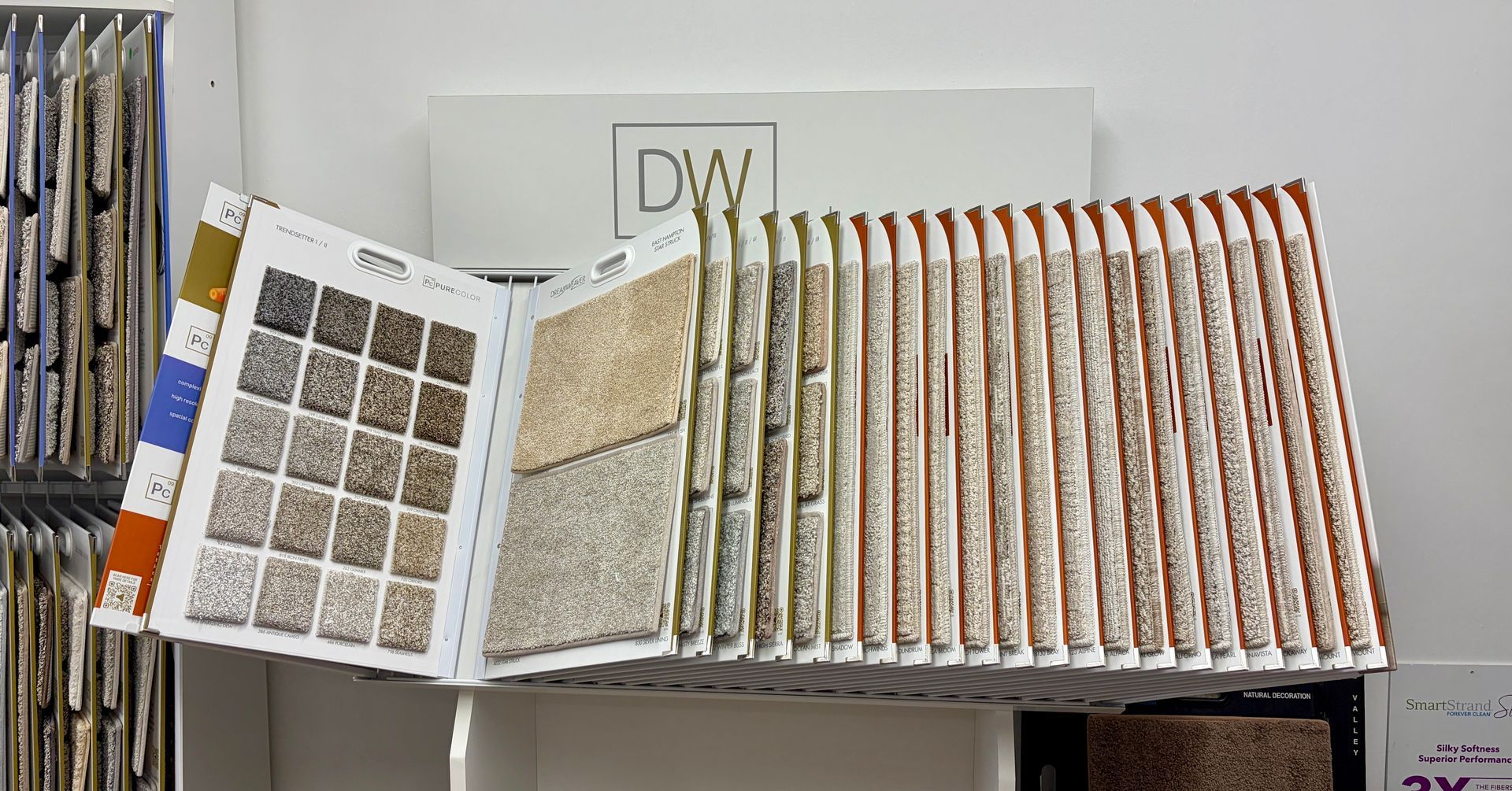 Carpet sample book display with various textures and colors.