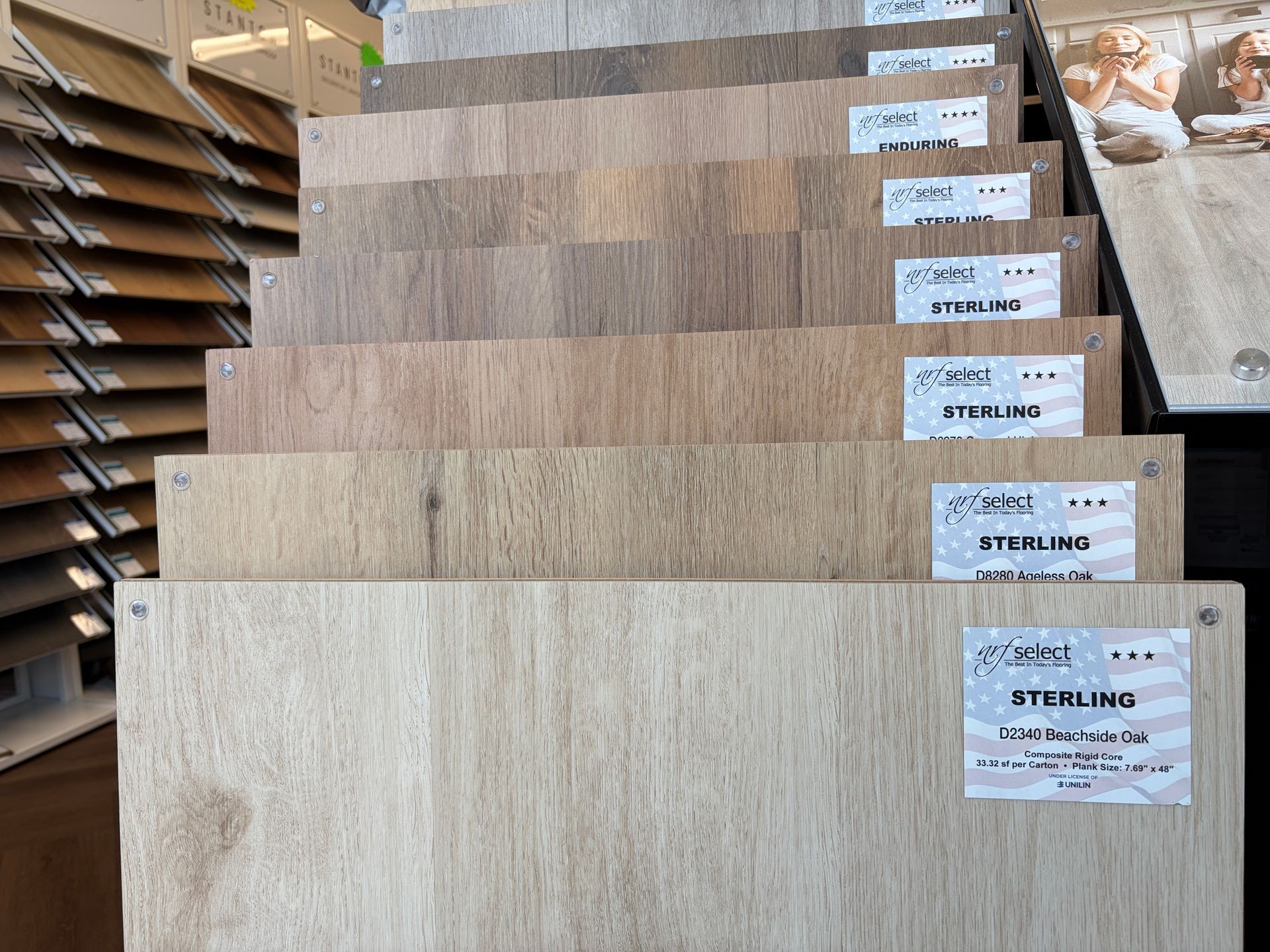 Samples of wood flooring in various shades, stacked, with label tags.