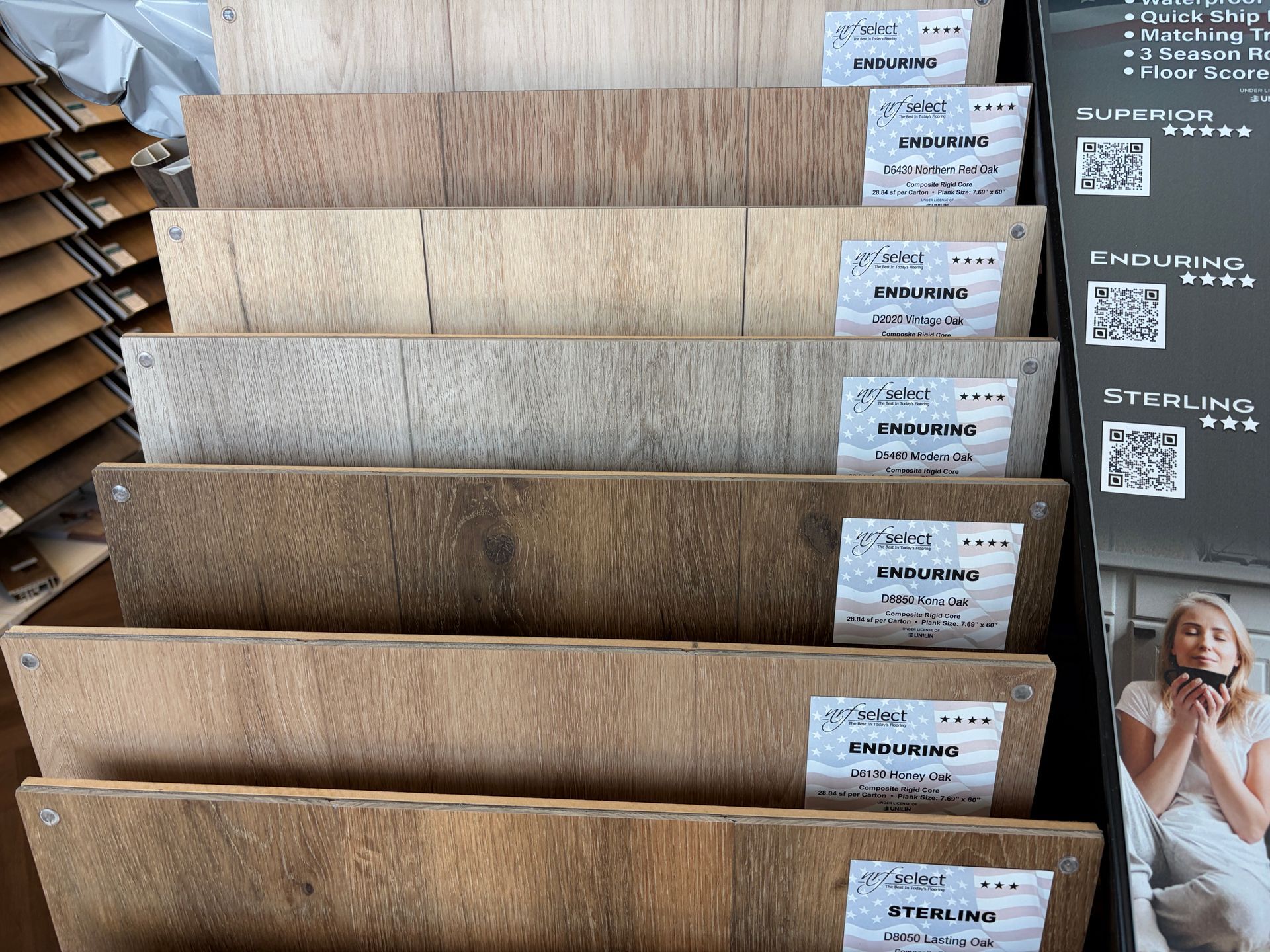 Display of wood flooring samples in various shades and textures.