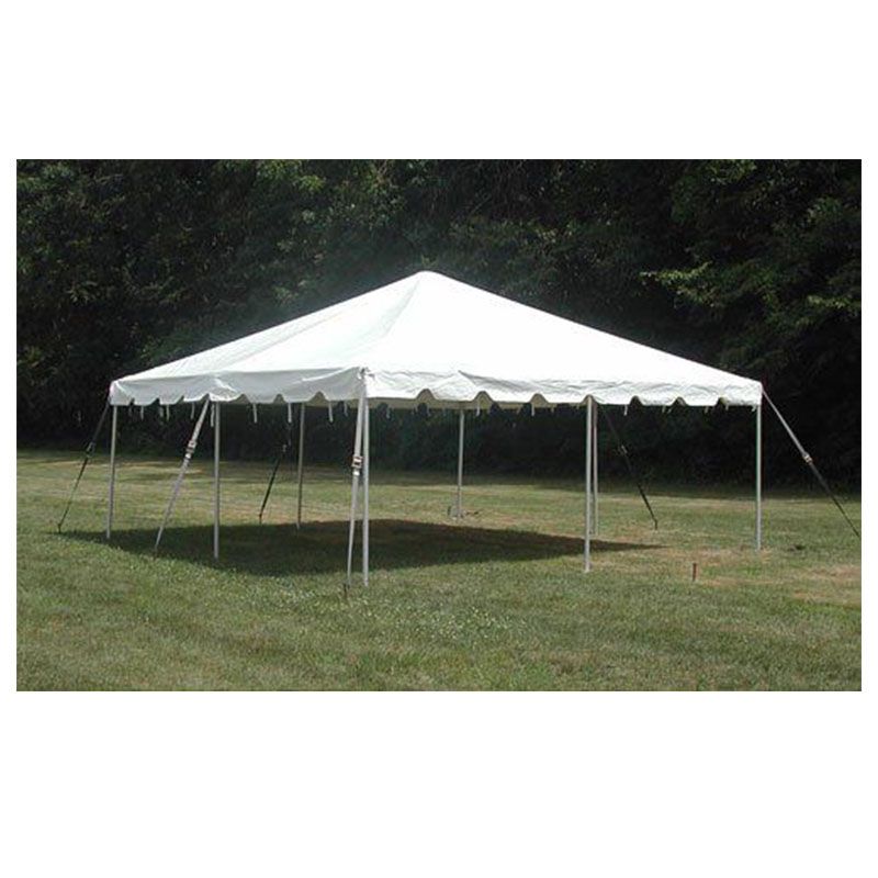 A white tent is sitting in the middle of a grassy field.