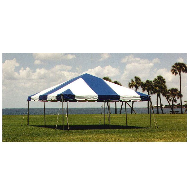 A blue and white tent is sitting on top of a lush green field.