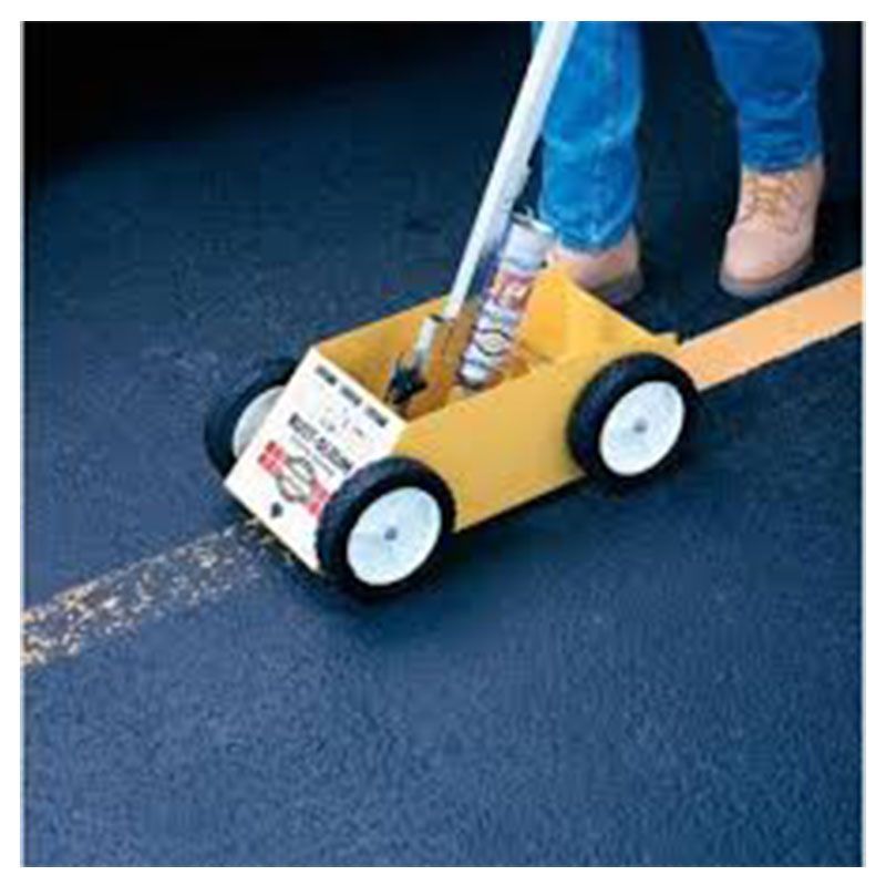 A person is using a yellow toy car to paint a yellow line on the road.