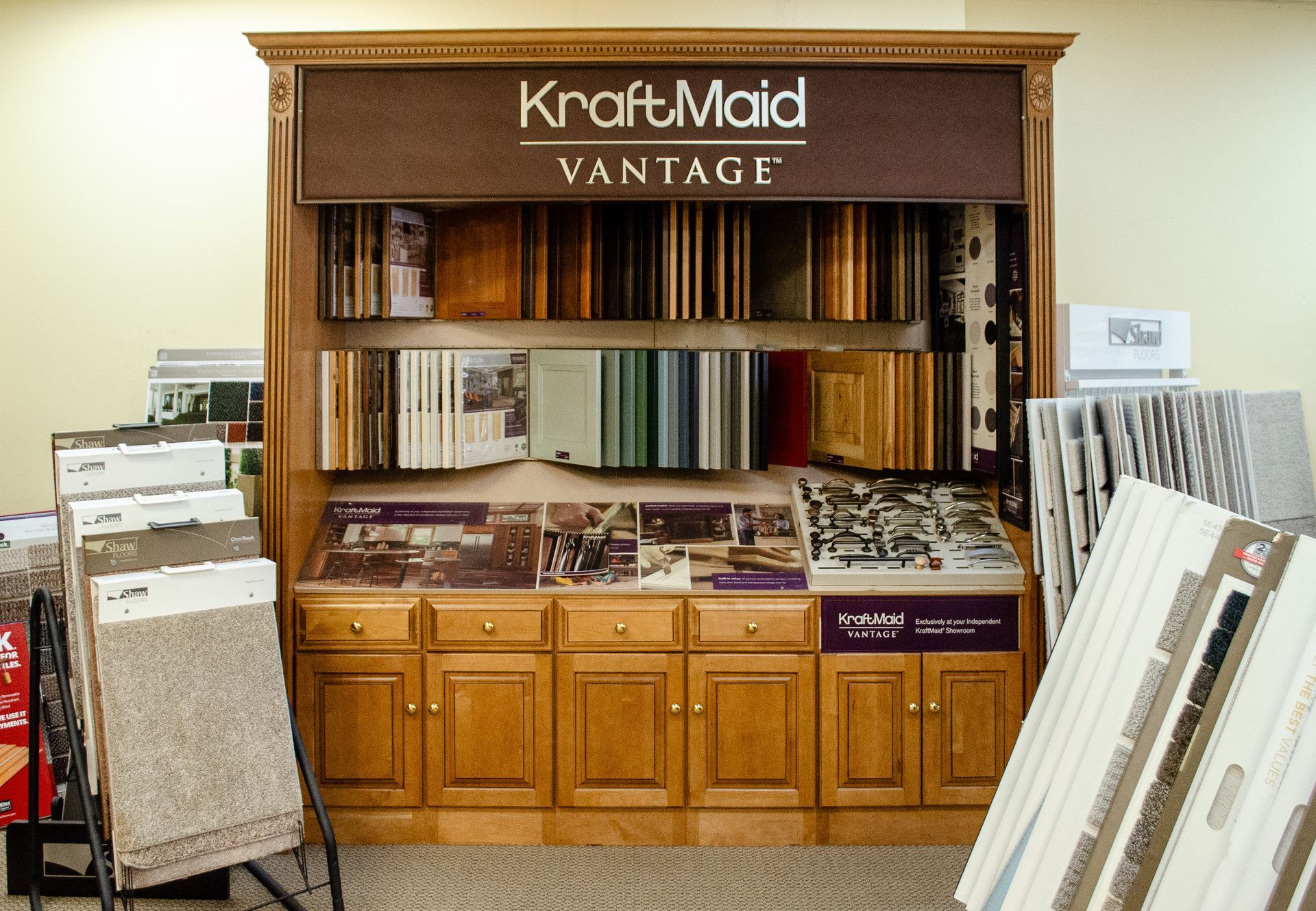 a wooden cabinet with a KraftMaid sign above it