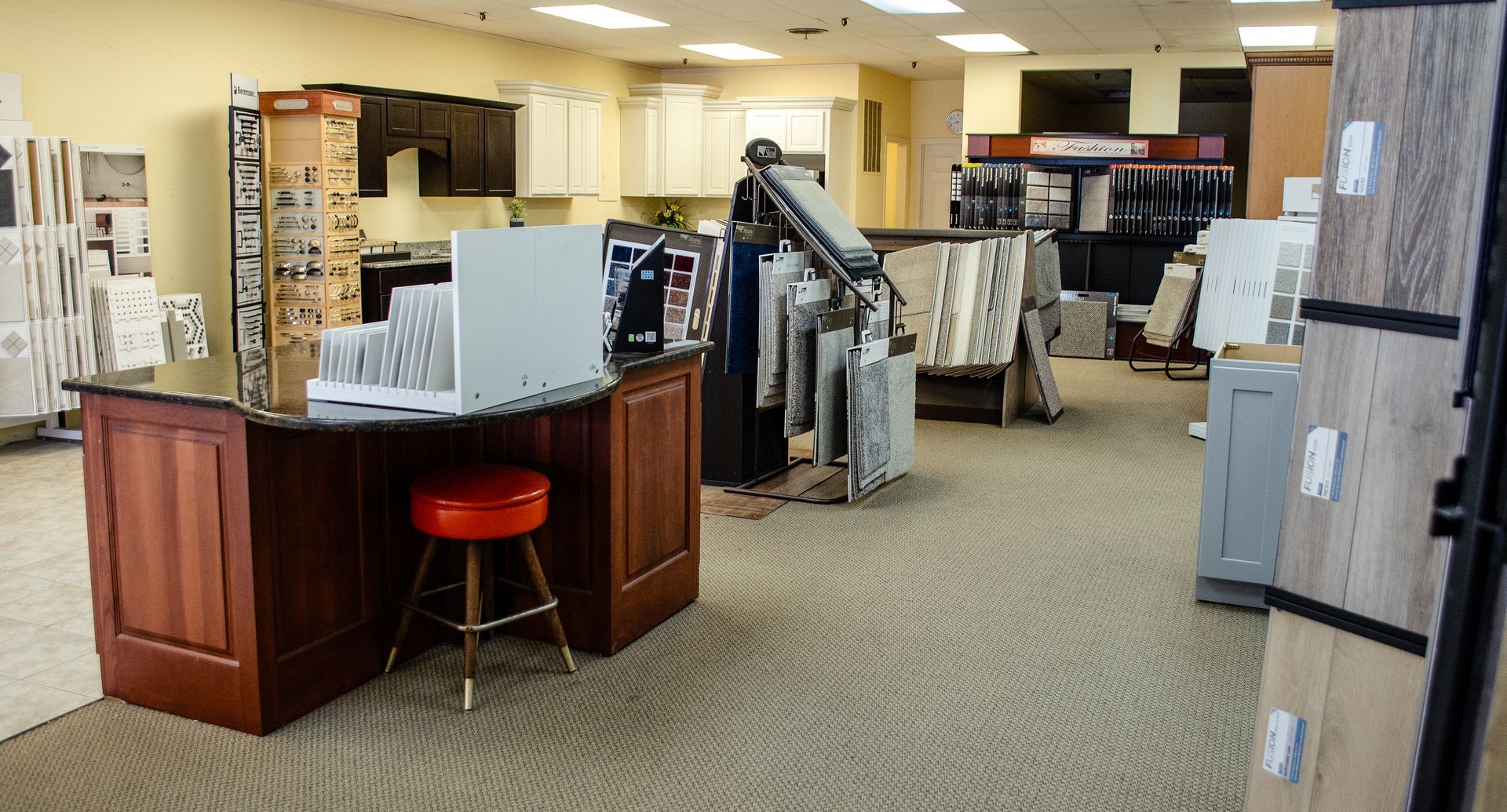 a large room with a desk and a stool in it