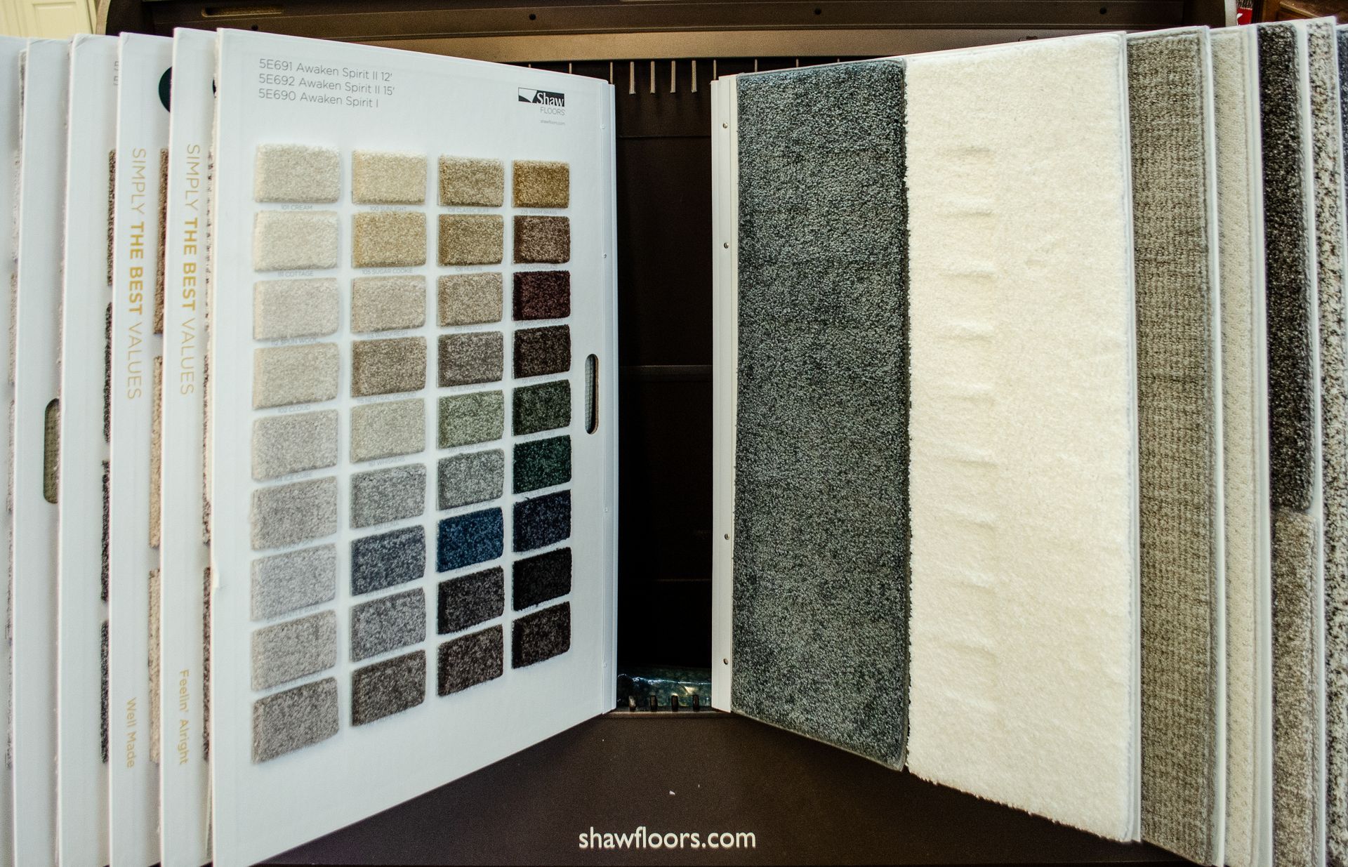 a book is open to a display of carpet samples