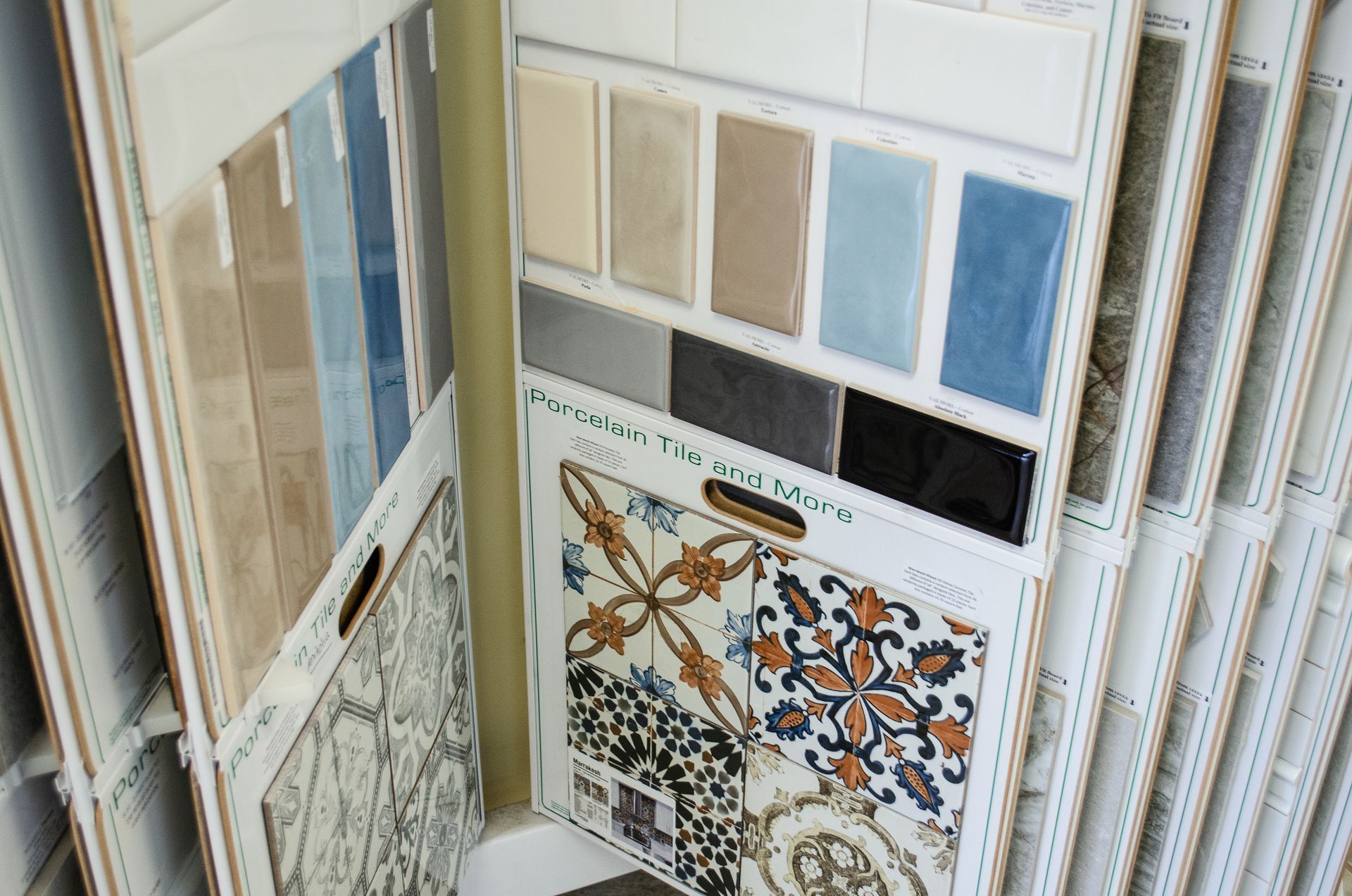 a variety of tiles are displayed on a rack in a store