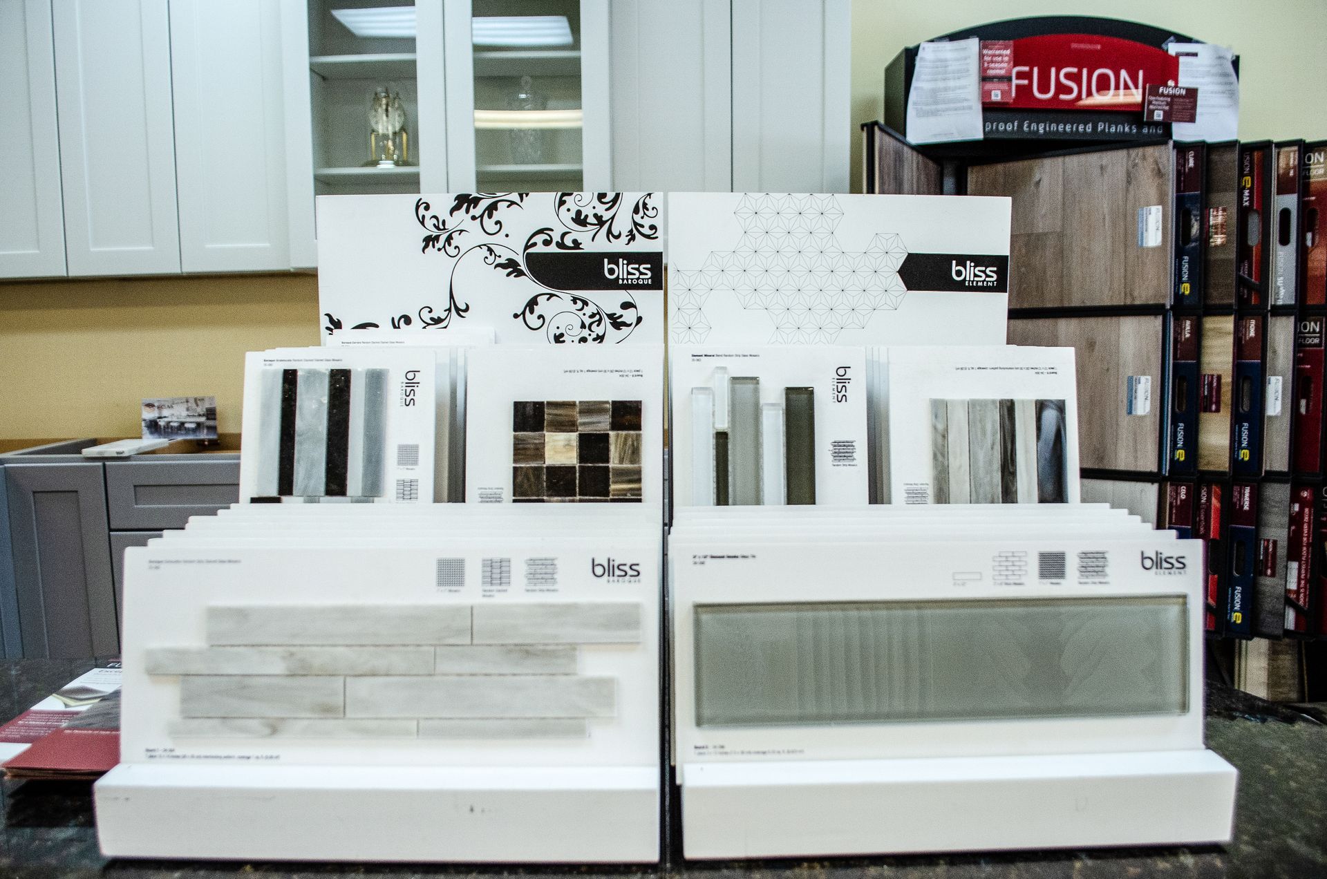 a display of tiles in a kitchen with a fusion sign in the background