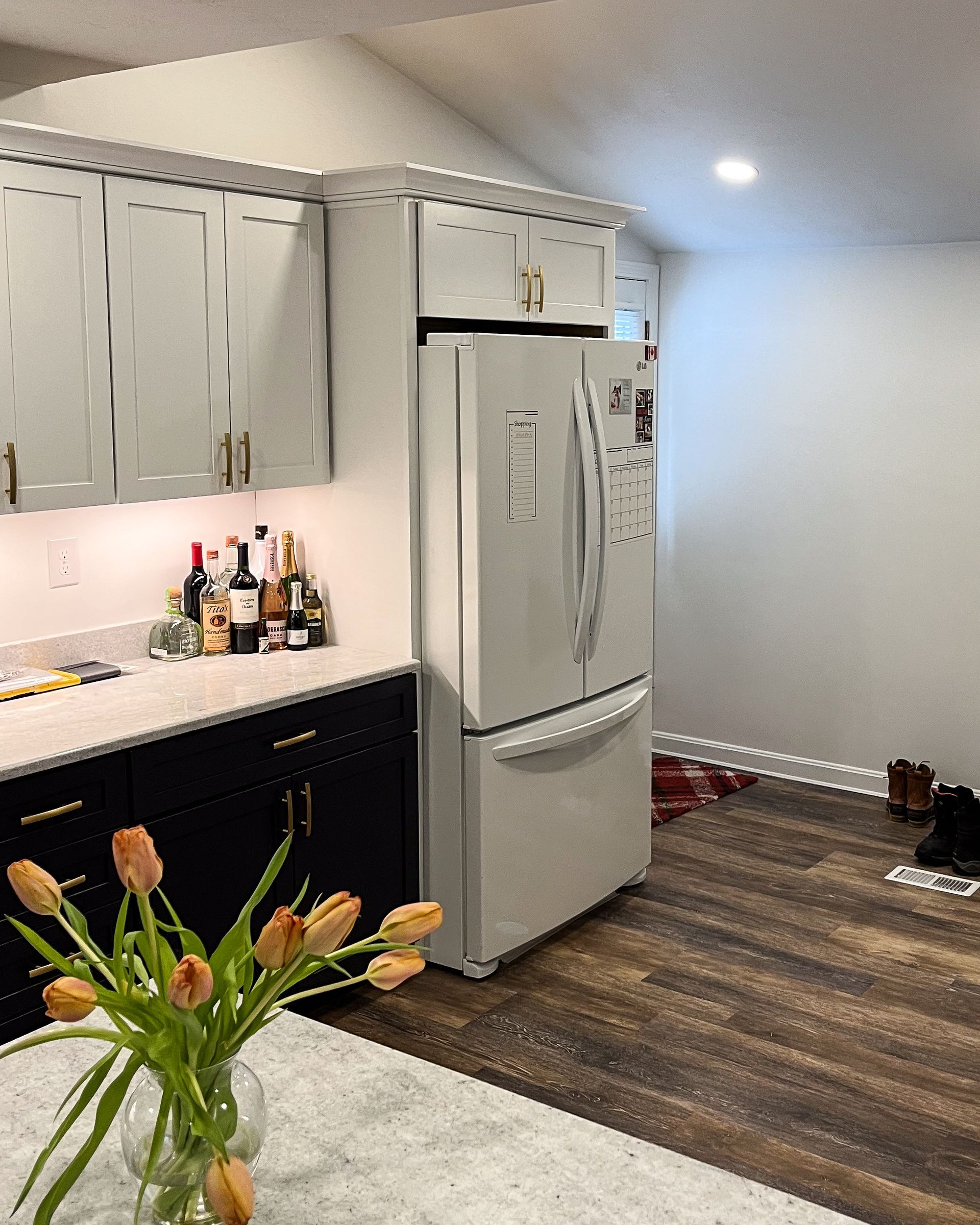 a kitchen with a large island in the middle and stainless steel appliances