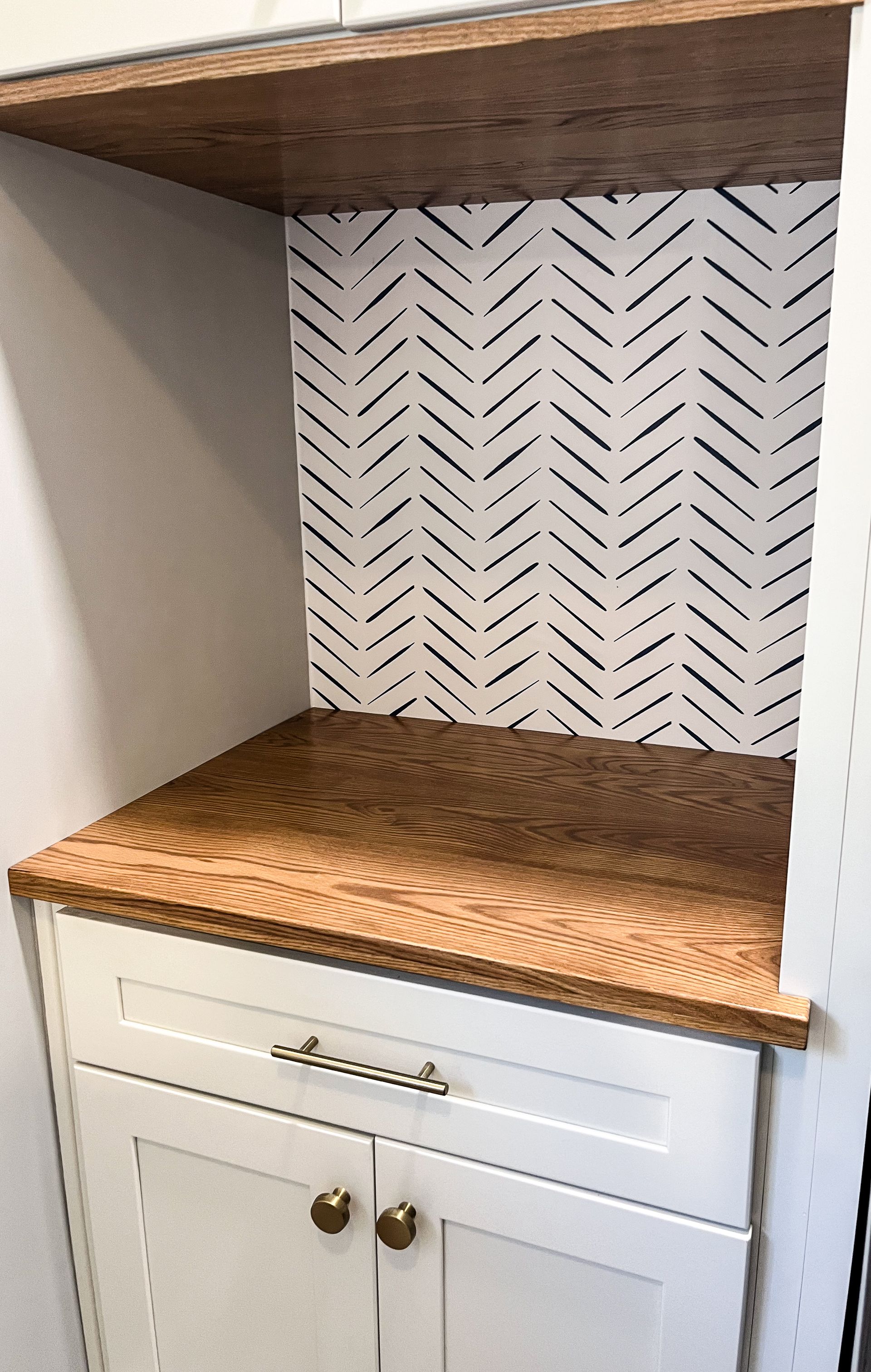 a kitchen with white cabinets and a coffee maker
