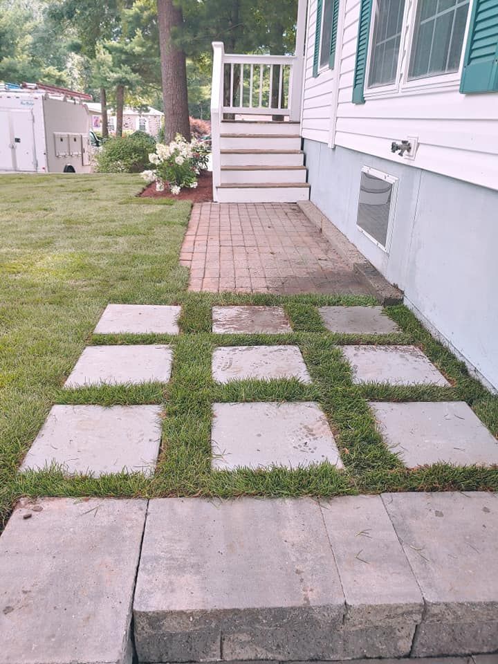 There is a walkway leading to the front door of a house.