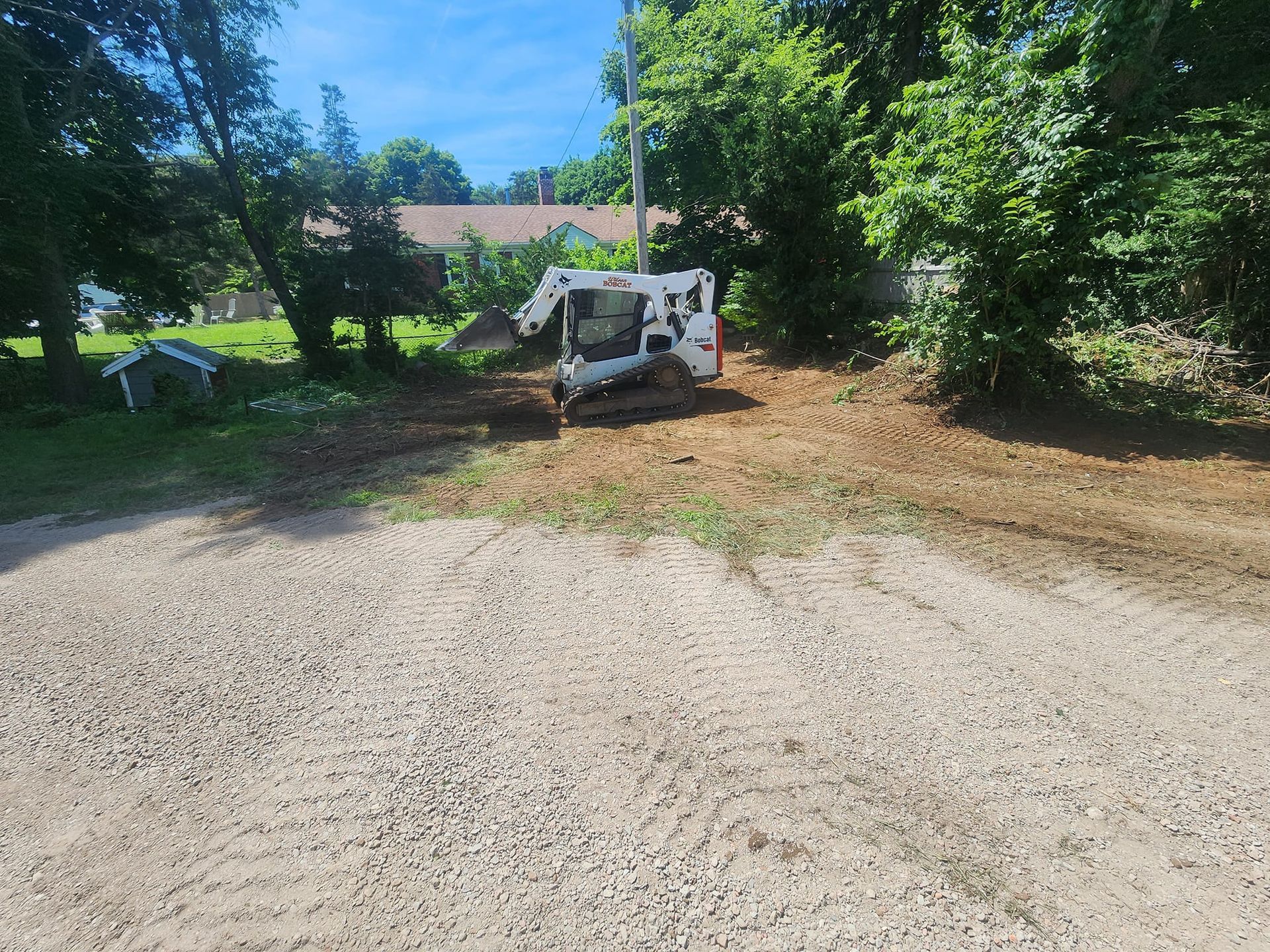 A bulldozer is sitting in the middle of a dirt road.