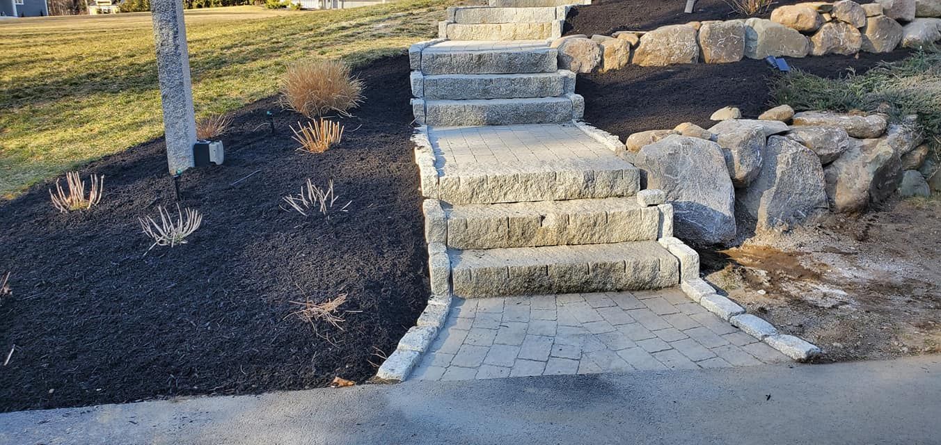 A stone walkway with stairs leading up to a house.