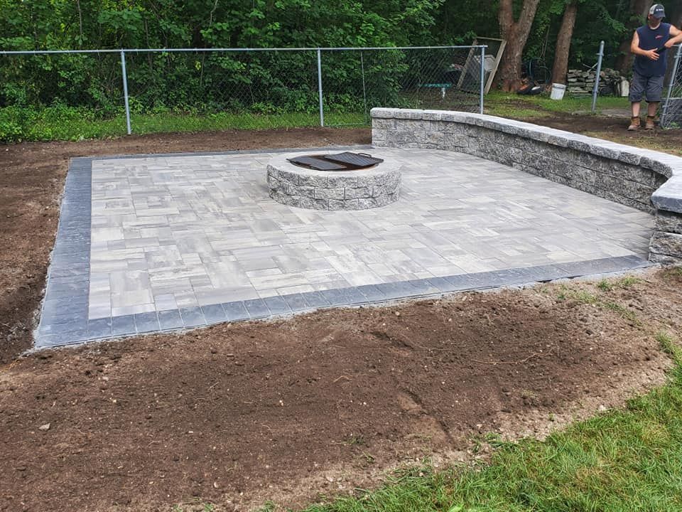 There is a fire pit in the middle of the patio.