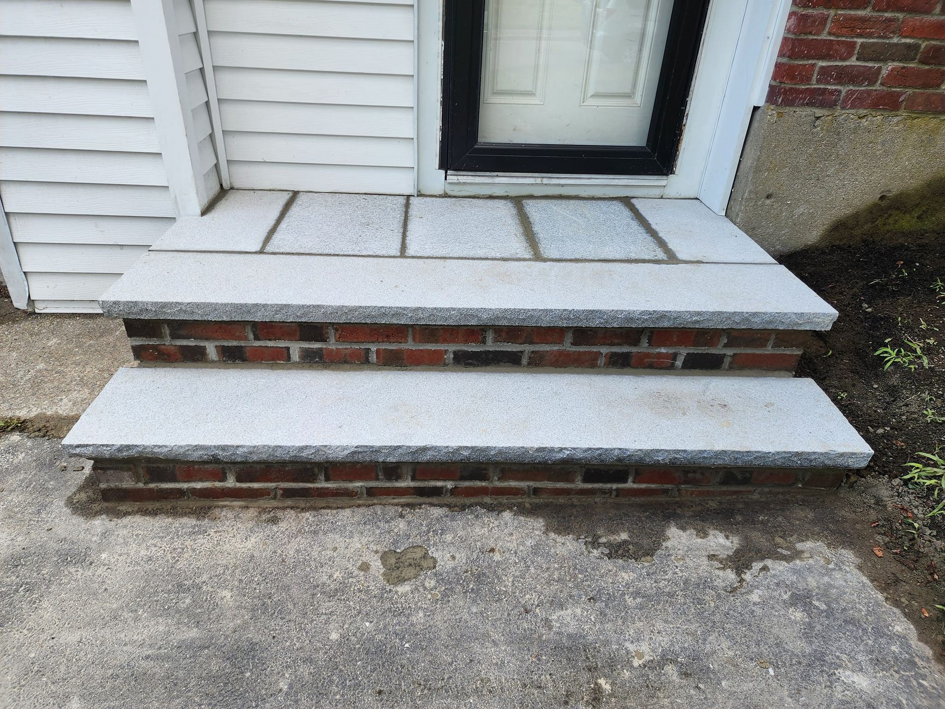 A set of stairs leading up to a doorway of a house.