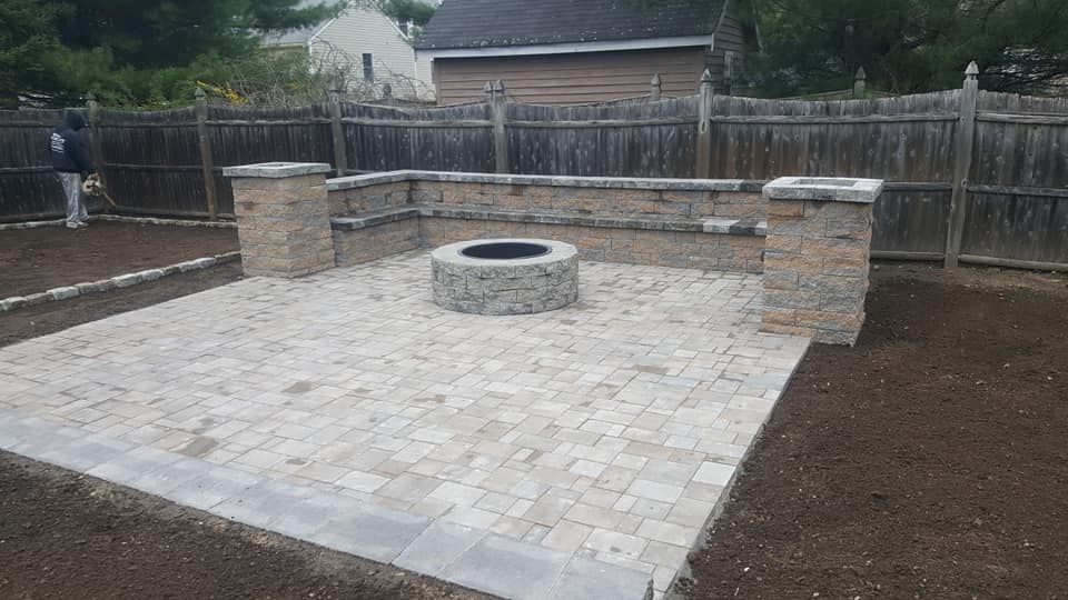 There is a fire pit in the middle of the patio.