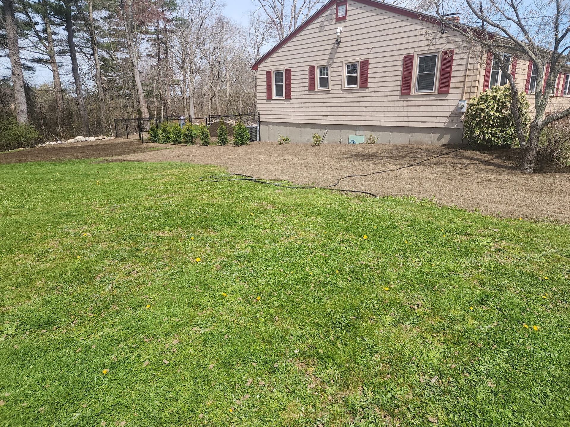 A house with a large lawn in front of it.