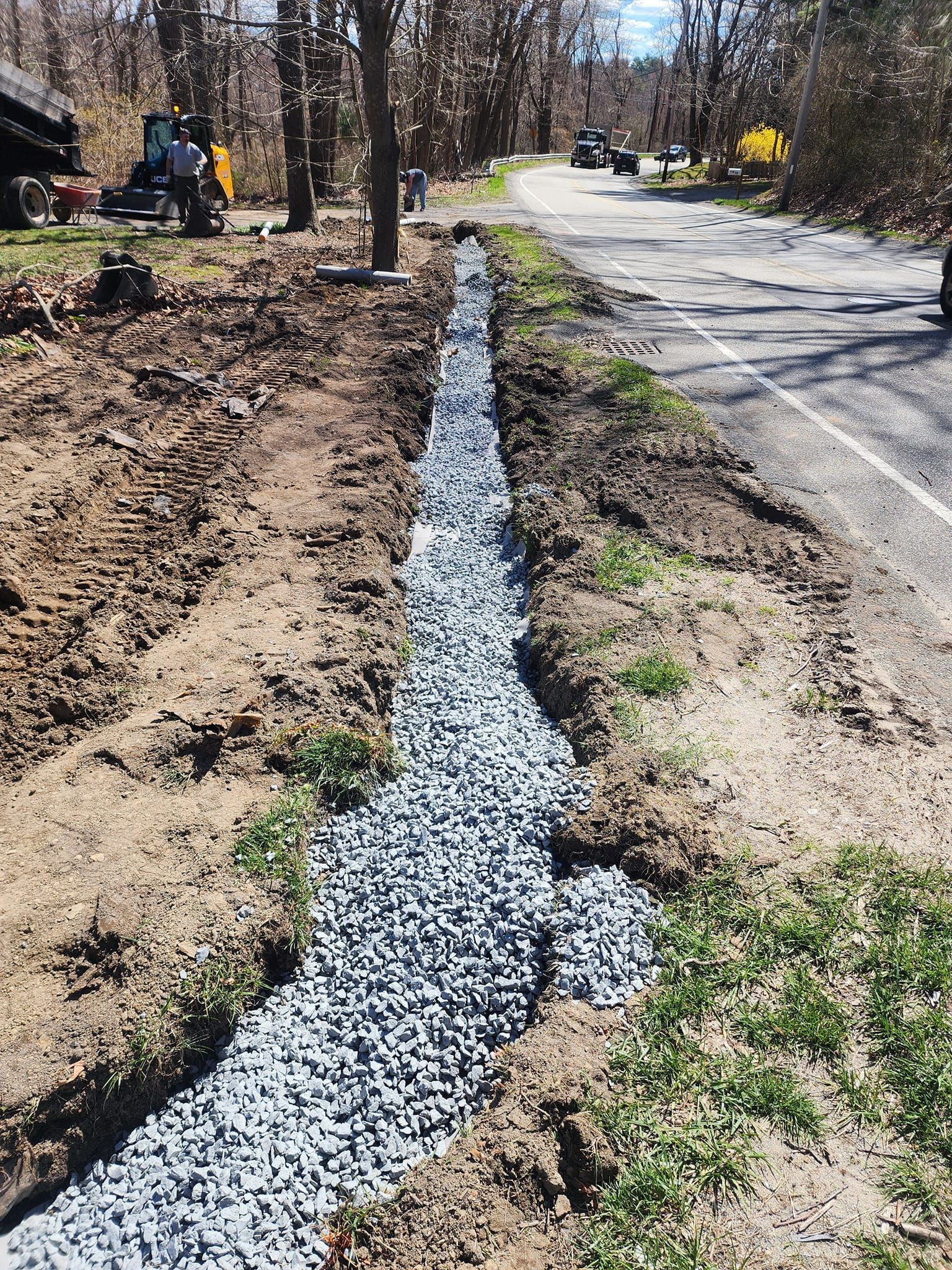 A drainage system is being installed on the side of a road.