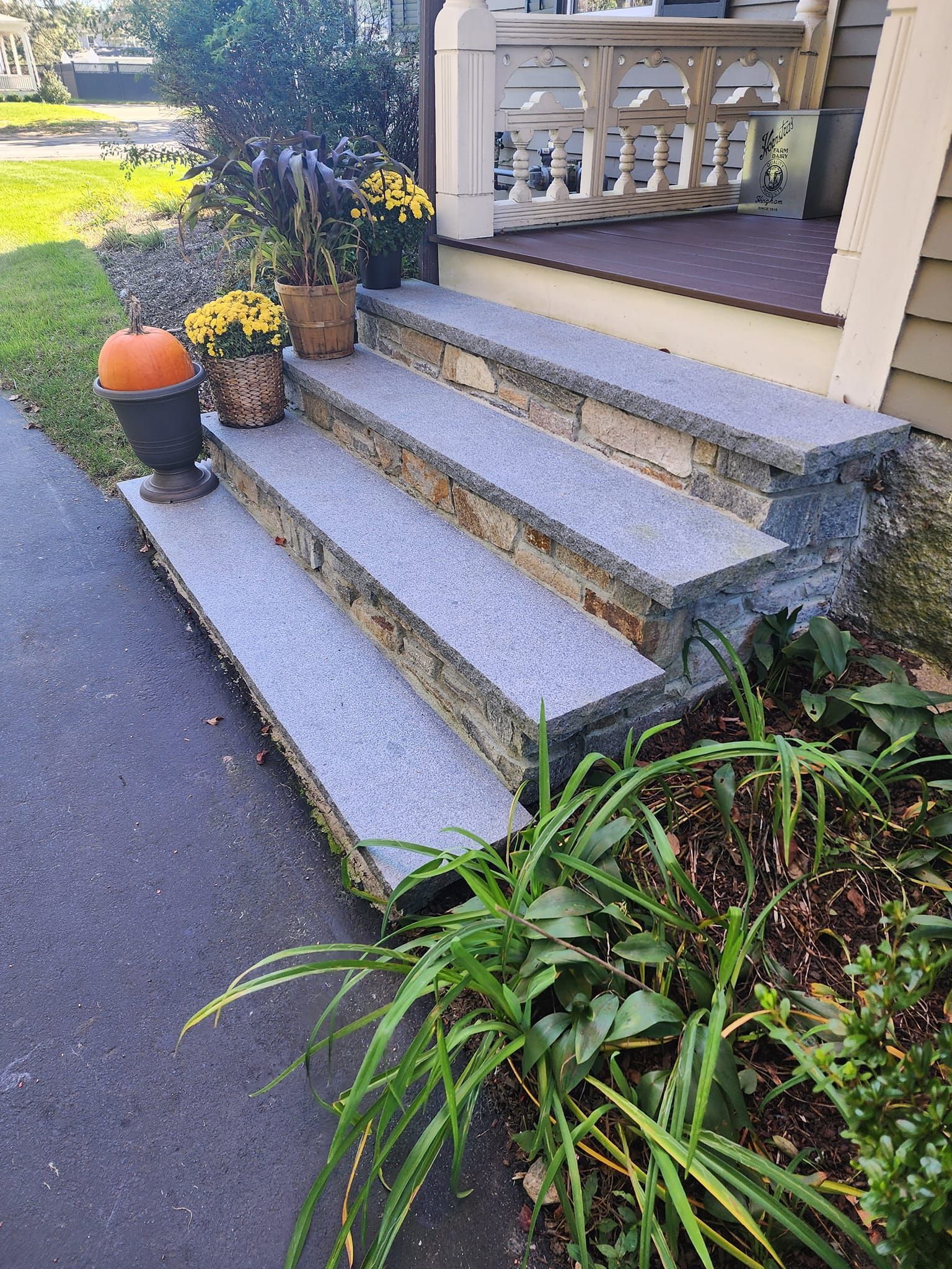 There is a pumpkin on the steps of a house.