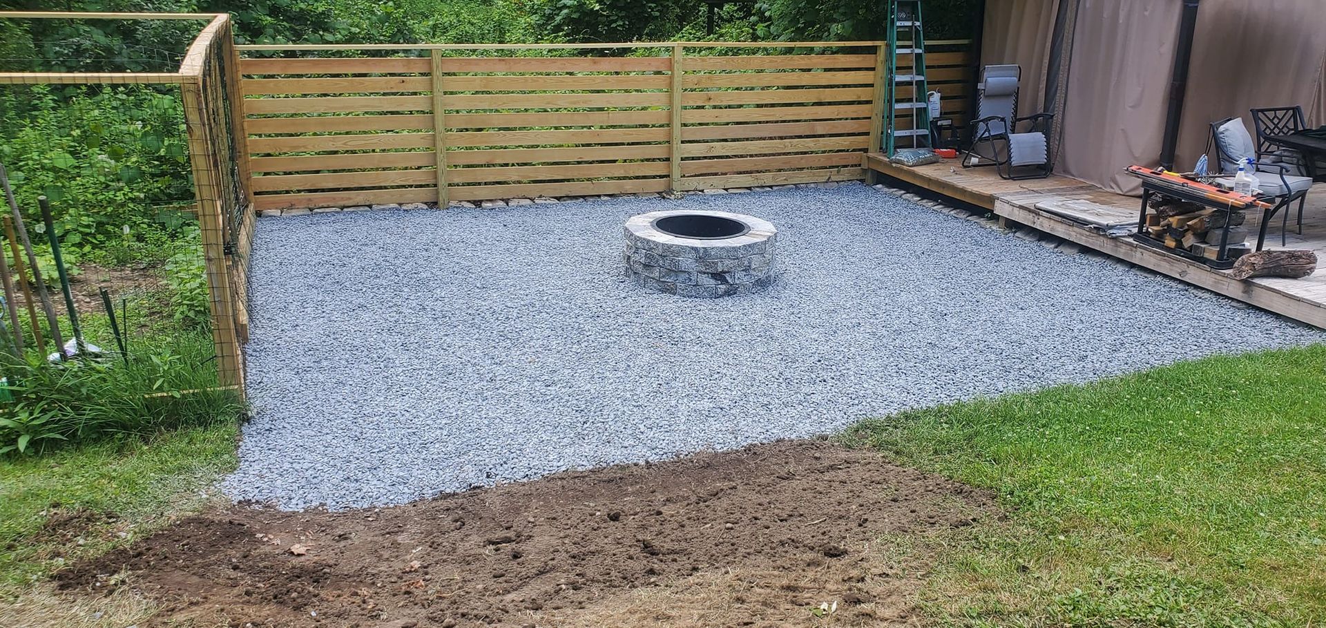 There is a fire pit in the middle of the backyard.