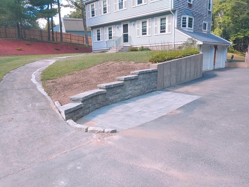 A house with a concrete walkway leading to it