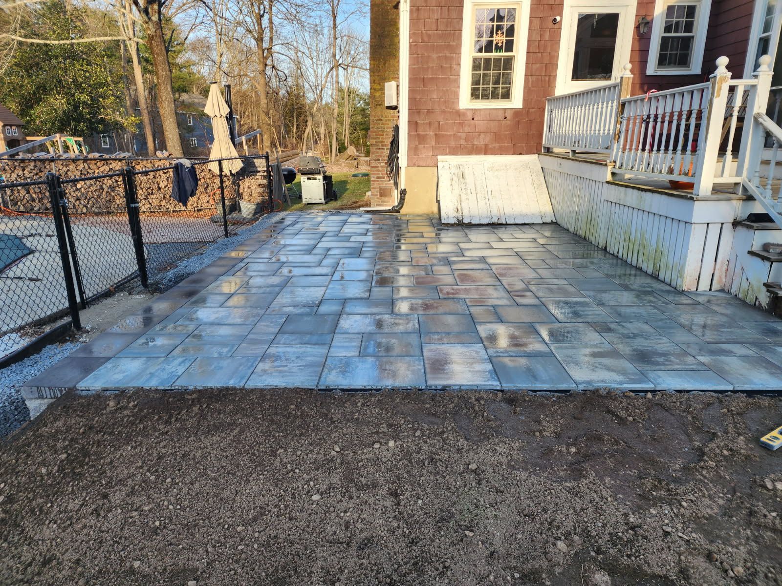 A patio is being built in front of a house.
