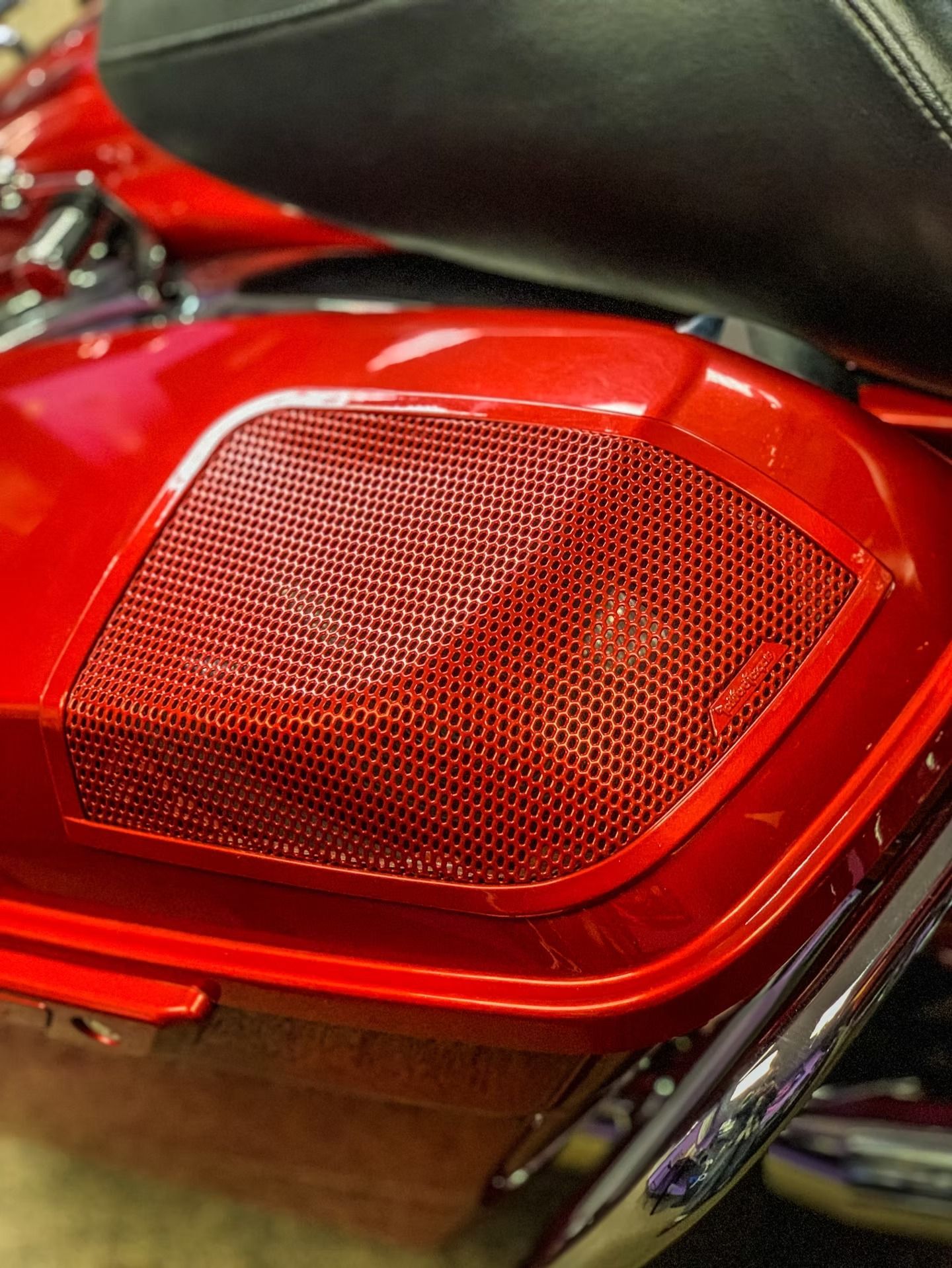 Close-up of a red motorcycle taillight and black seat detail