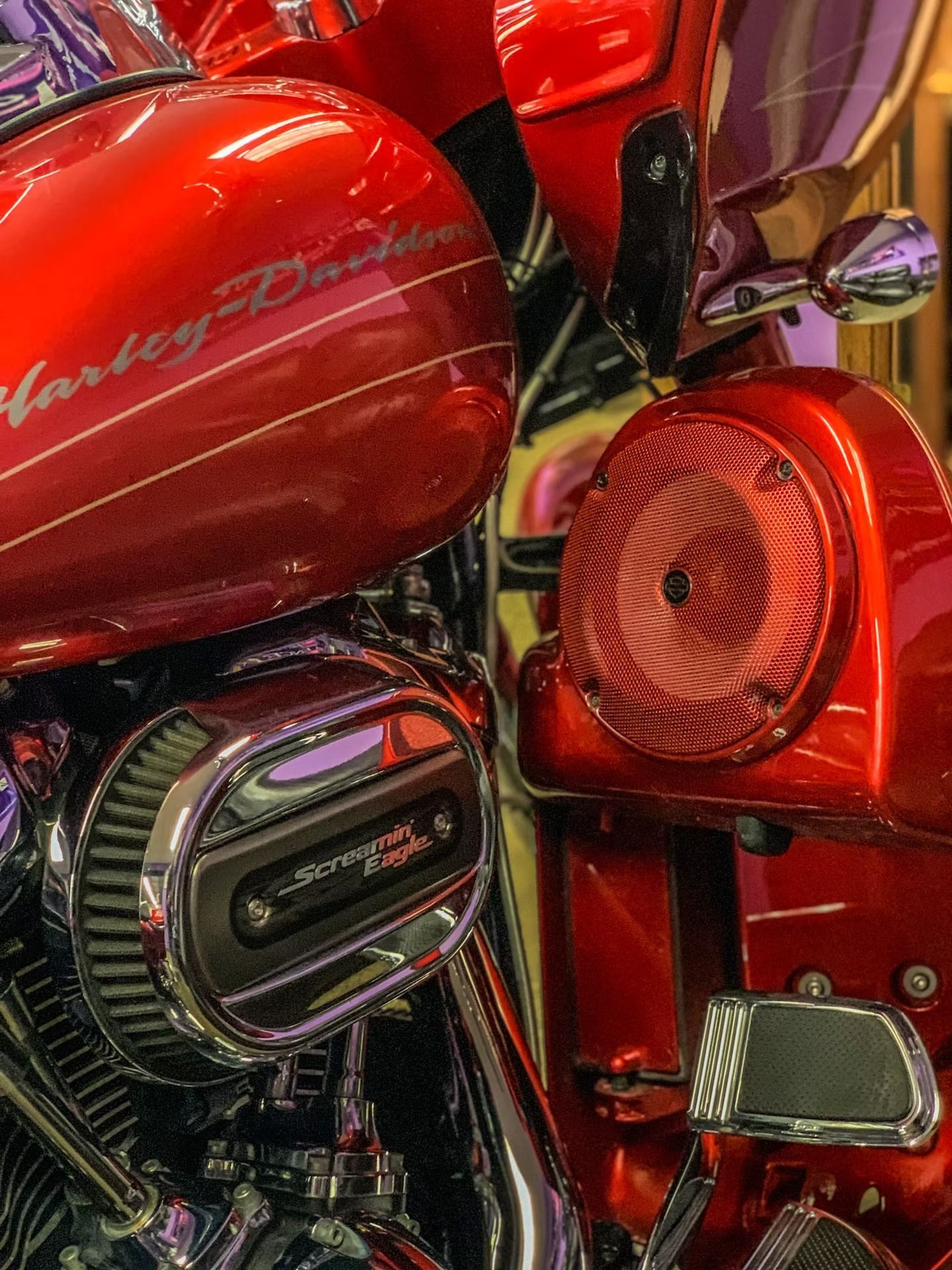 Close-up of a shiny red motorcycle engine and chrome details