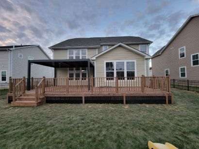 A large house with a large deck in front of it.