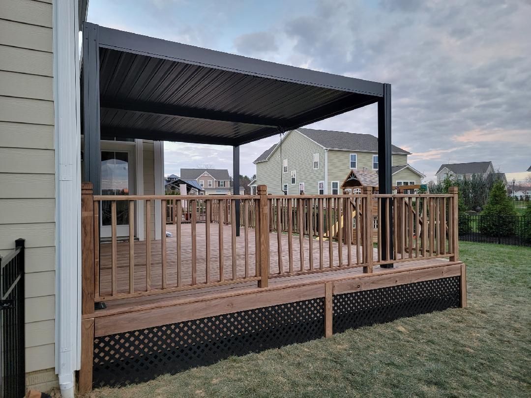 A wooden deck with a pergola on top of it.