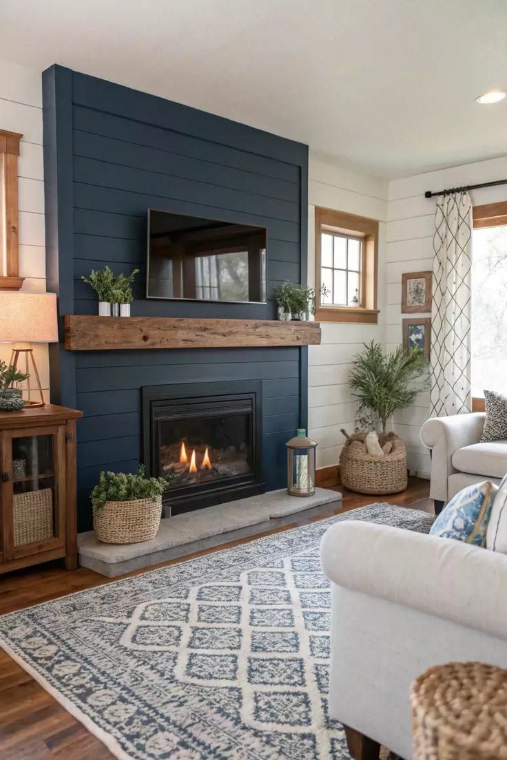 Cozy living room with navy blue fireplace, TV, and light-colored rug.