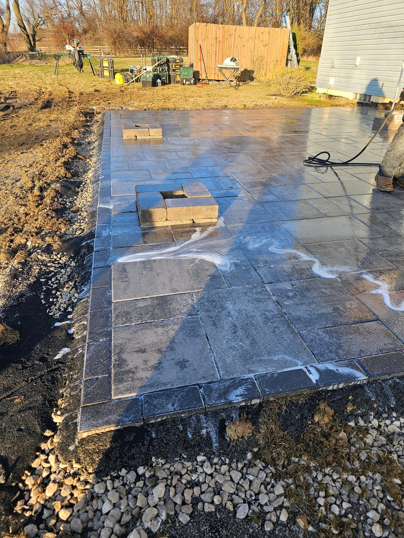 A large piece of concrete is sitting on top of a pile of gravel.