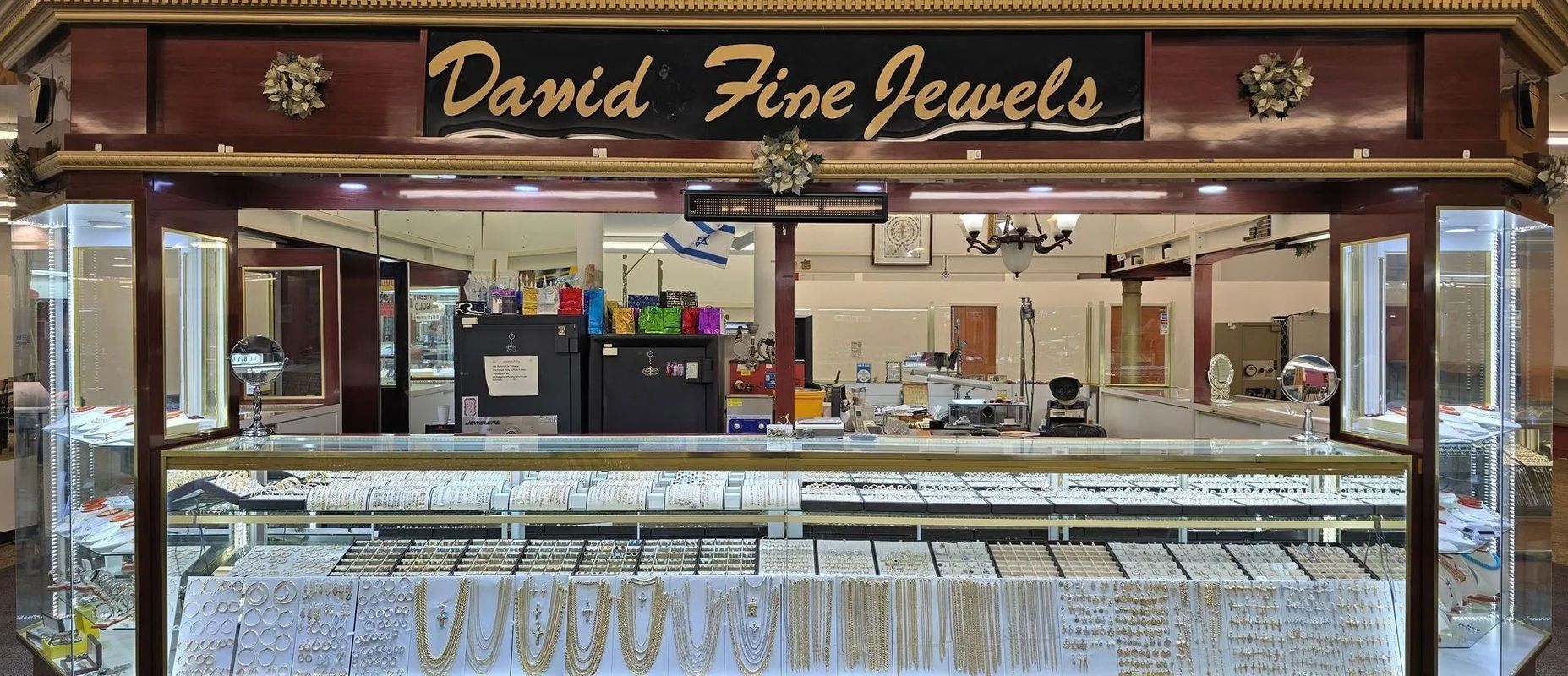 David Fine Jewels jewelry store display. Interior, with merchandise in display cases and sign overhead.