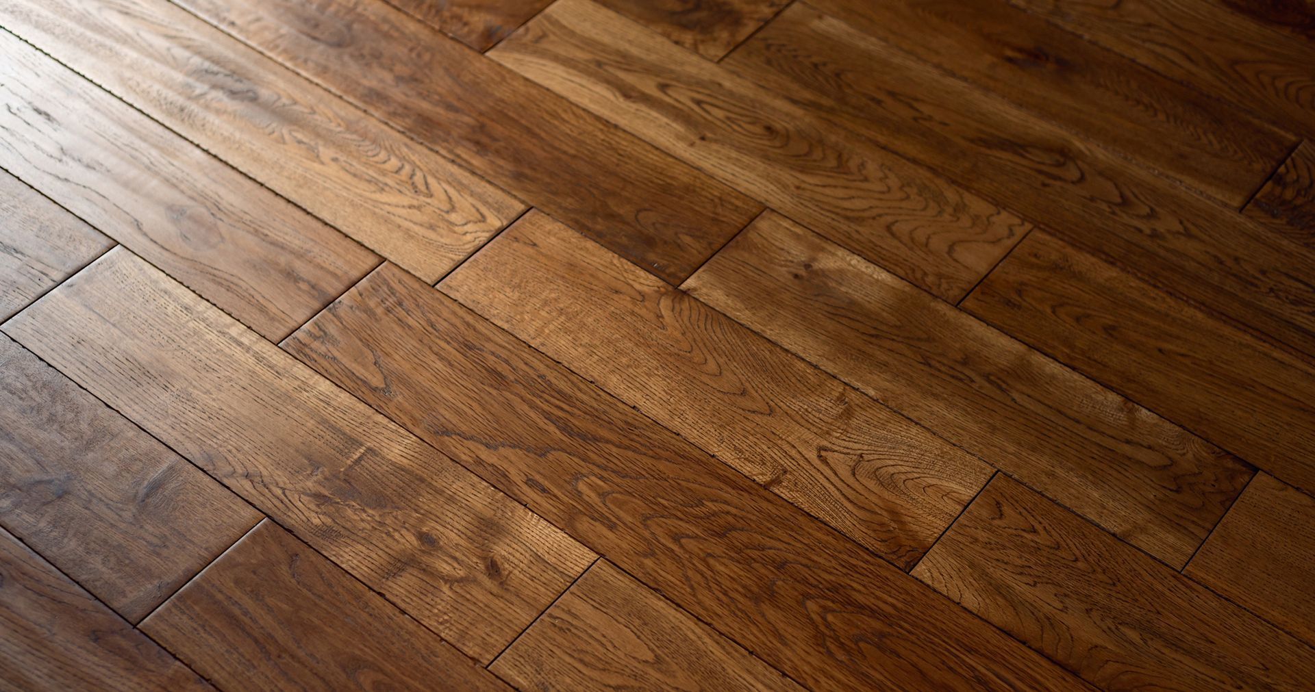 Wood floor, dark brown with textured grain, installed in a diagonal pattern.