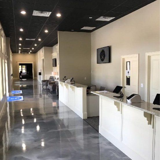 A long hallway in a building with white counters