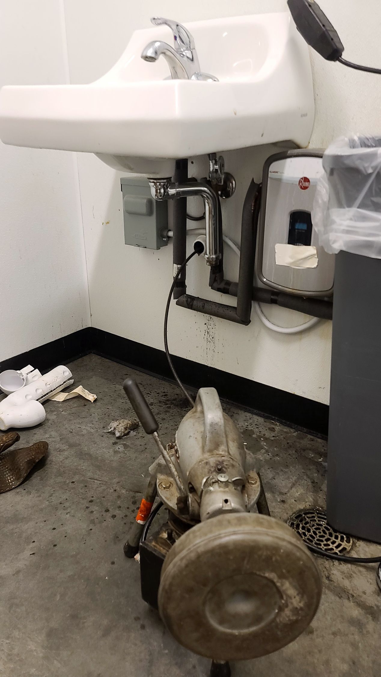 Ridgid k-50 cleaning a bathroom sink line. Professional sewer line cleaning equipment removing a blockage from a residential sewer pipe.