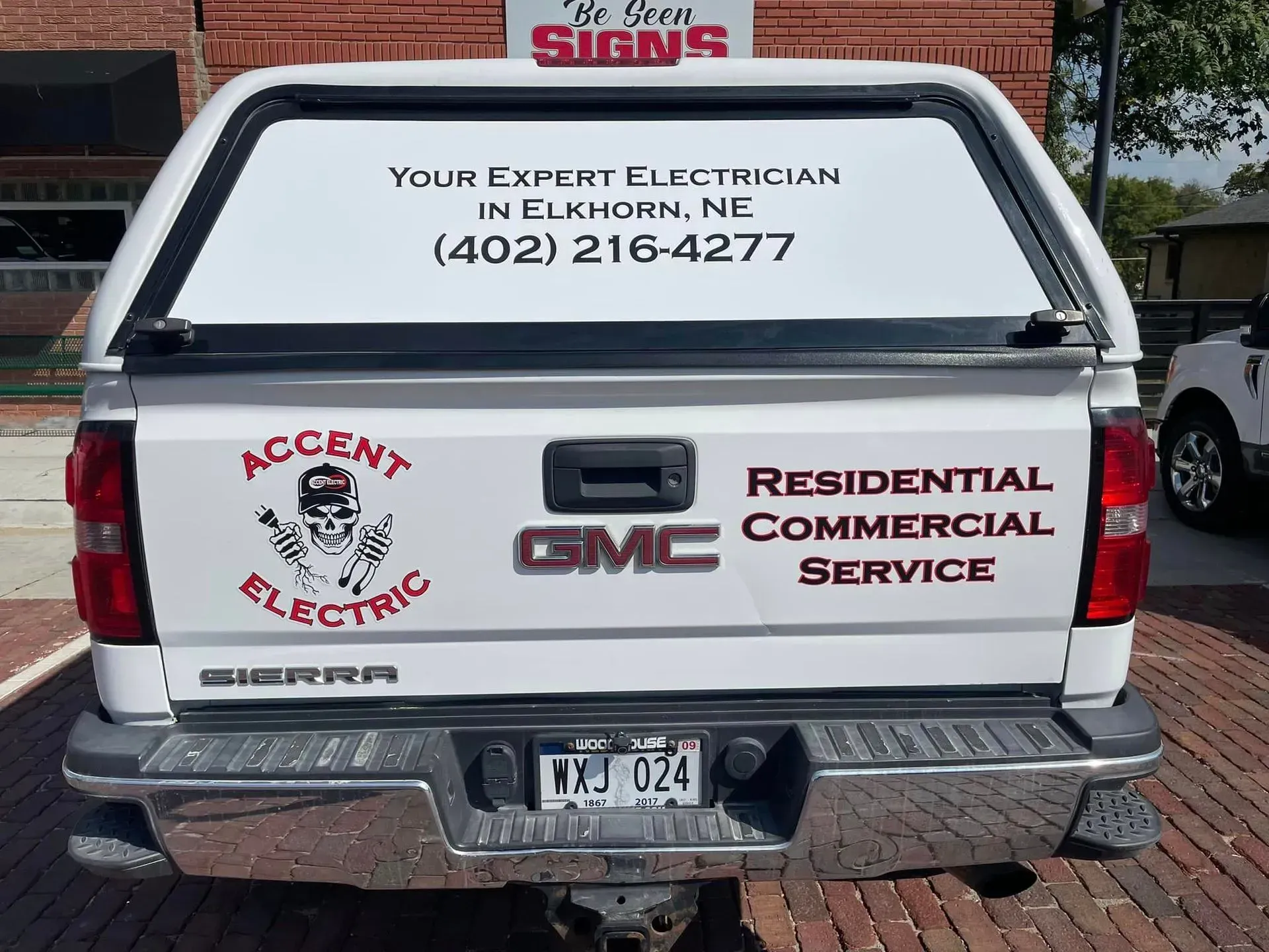 A white GMC Sierra truck for Accent Electric, advertising residential and commercial services in Elkhorn, Nebraska.