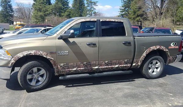 A dodge ram truck is parked in a parking lot.