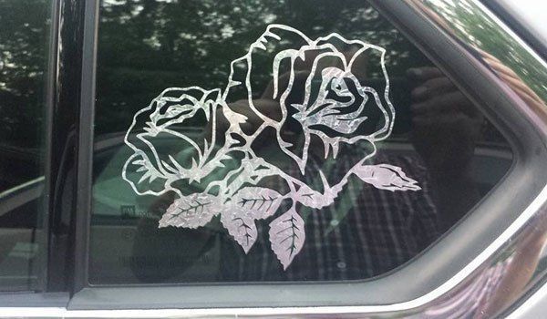 A car window with a picture of two roses on it.
