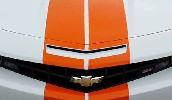 The front of a chevrolet camaro with orange and white stripes