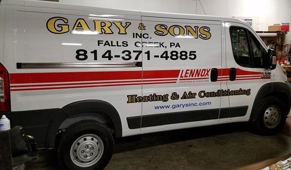 A white van that says gary & sons on the side