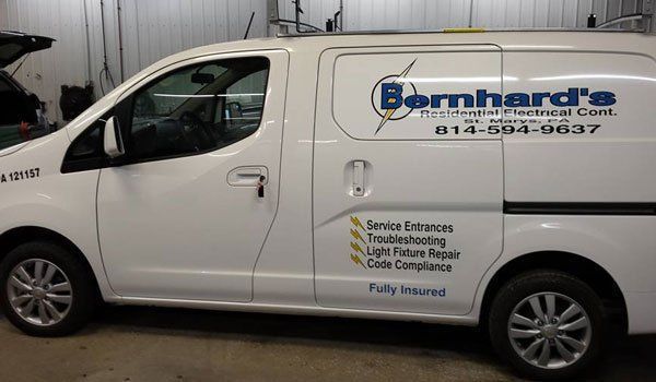 A white bernhard 's van is parked in a garage