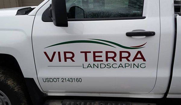 A white truck with vir terra landscaping written on the door