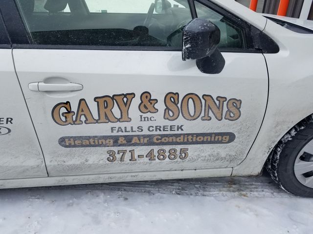 A white car that says gary & sons on the side