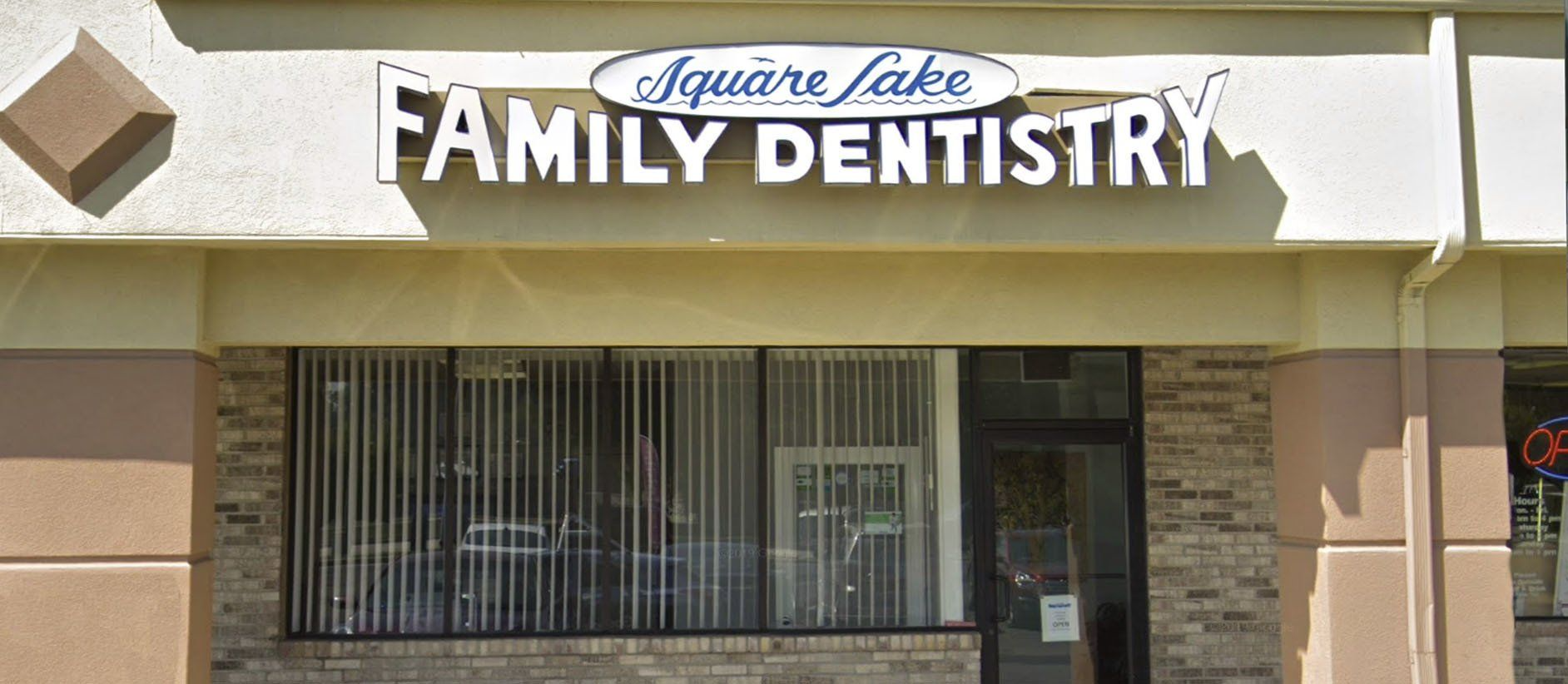 Sign for Square Lake Family Dentistry over a storefront.