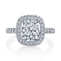 Diamond engagement ring with a square-cut center stone and halo setting, on a white background.