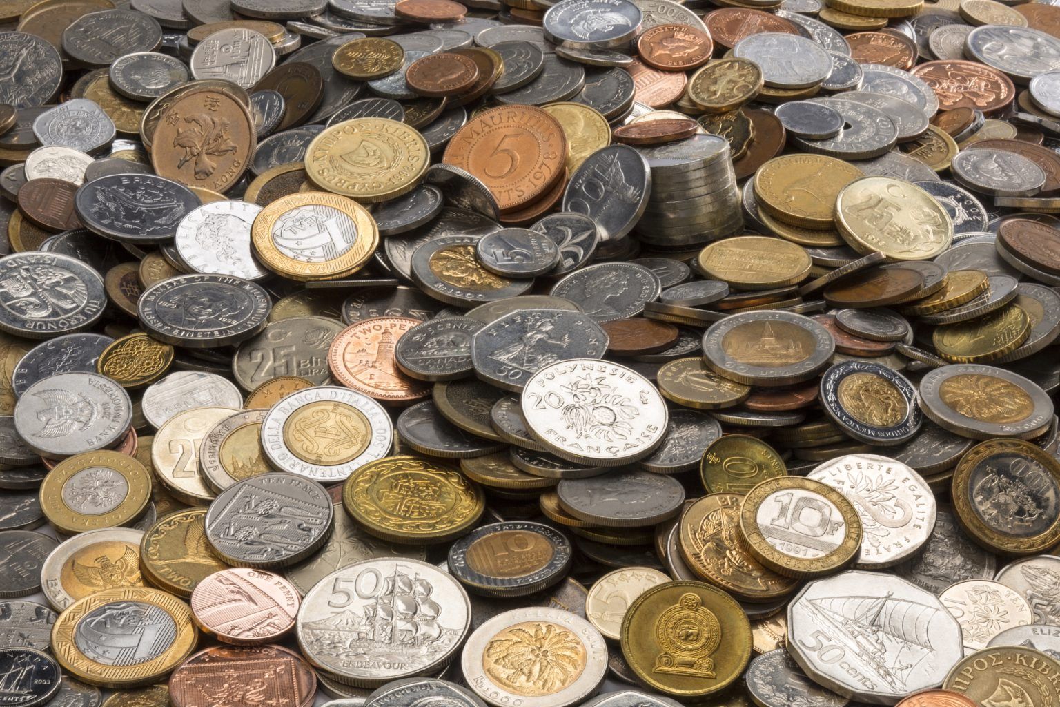 Pile of assorted international coins.