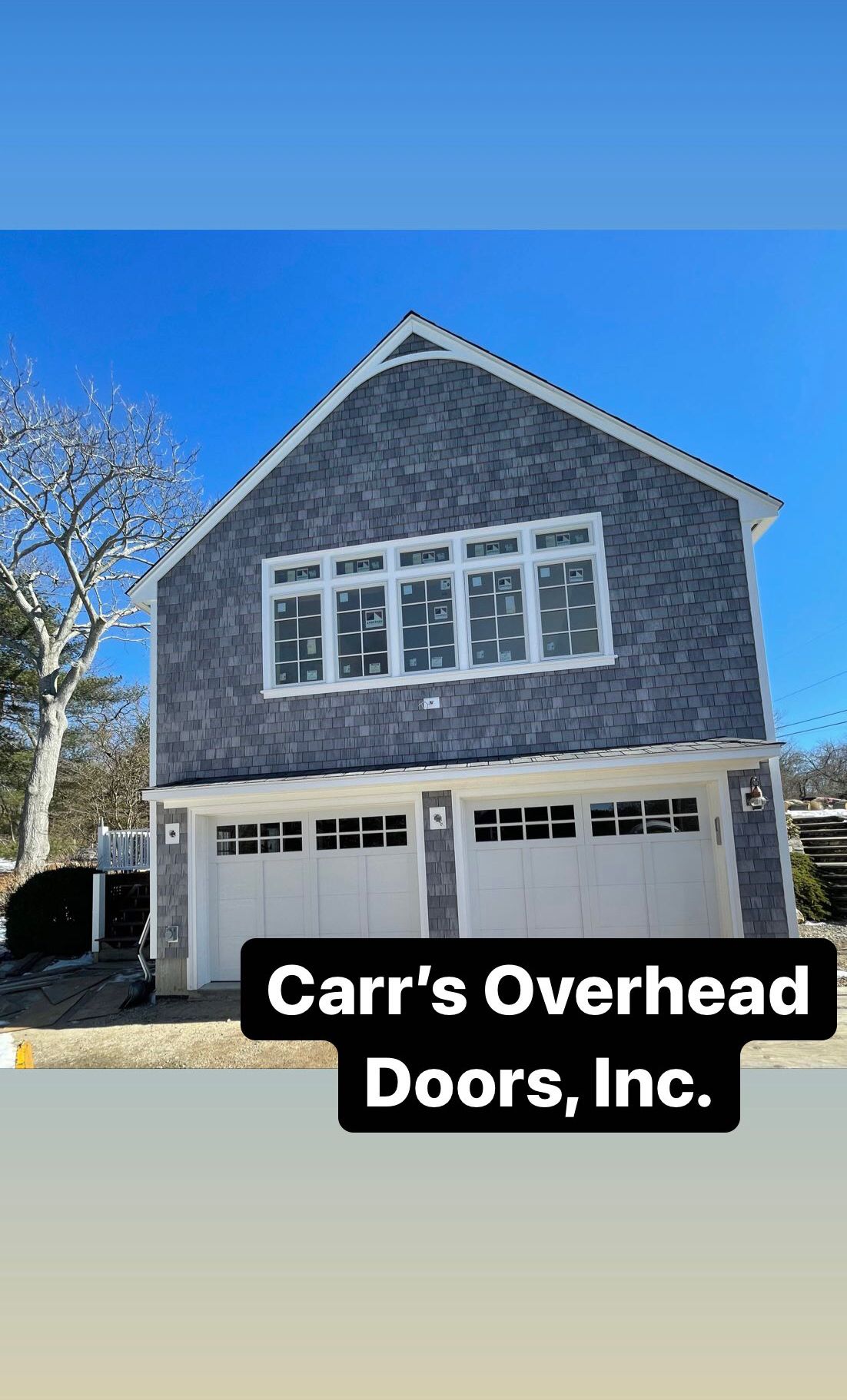 Two-story building with two garage doors and multiple windows; Carr's Overhead Doors, Inc. logo at the bottom.