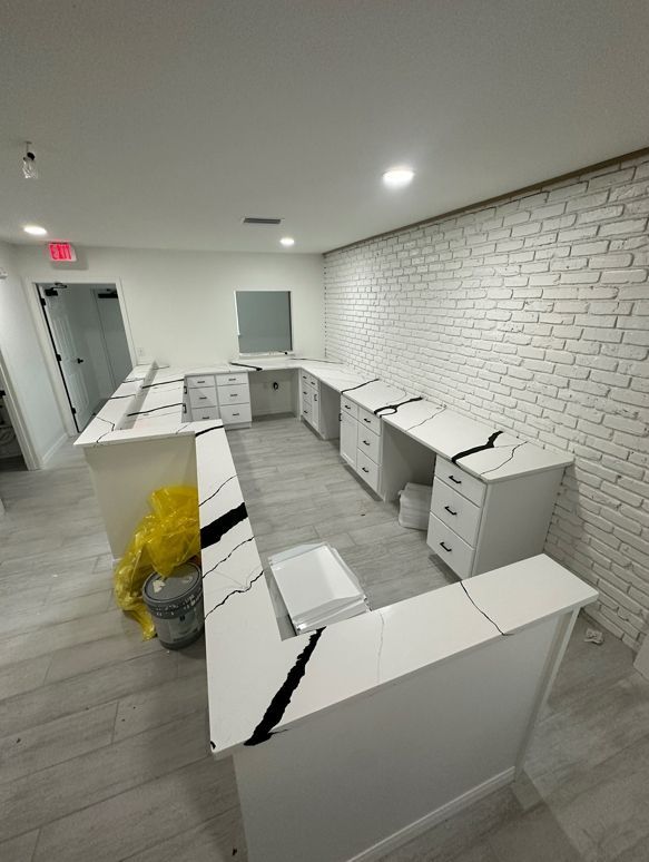 A room with white brick walls and white counter tops.