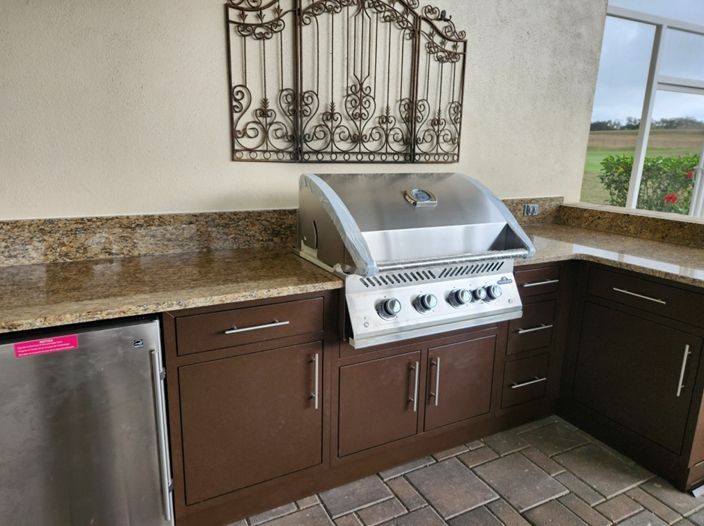 A kitchen with stainless steel appliances and a grill